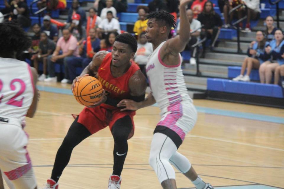 Deerfield Beach’s Jason Morris goes up for a shot as Palmetto’s Randy Smith defends during the Bucks’ 64-55 win over the Panthers on Tuesday night in a Region 4-7A semifinal at Palmetto.