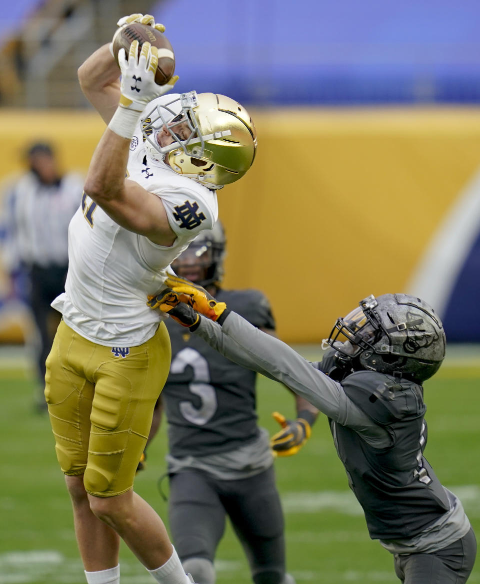 Notre Dame wide receiver Ben Skowronek (11) makes a catch over Pittsburgh defensive back Marquis Williams (14) and takes it in for a touchdown during the first half of an NCAA college football game, Saturday, Oct. 24, 2020, in Pittsburgh. (AP Photo/Keith Srakocic)