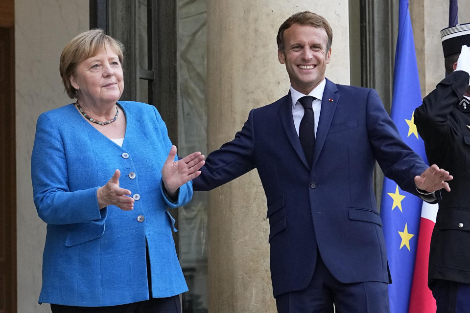 France's President Emmanuel Macron, right, welcomes German Chancellor Angela Merkel prior to a meeting at the Elysee Palace, in Paris, Thursday, Sept. 16, 2021. (AP Photo/Michel Euler)