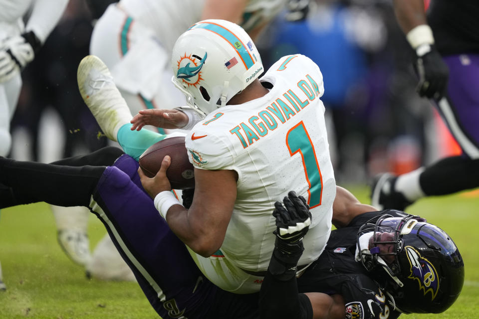 Miami Dolphins quarterback Tua Tagovailoa (1) is sacked by Baltimore Ravens linebacker Odafe Oweh (99) during the second half of an NFL football game in Baltimore, Sunday, Dec. 31, 2023. (AP Photo/Matt Rourke)