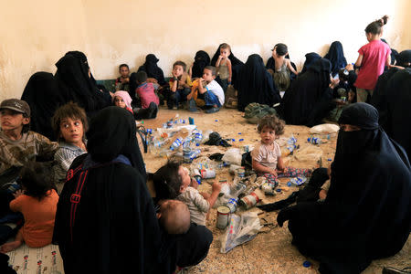 FILE PHOTO: Families and relatives of Islamic State militants are seen after they surrender themselves to the Kurdish Peshmerga forces in al-Ayadiya, northwest of Tal Afar, Iraq, August 30, 2017. REUTERS/Ari Jalal/File Photo