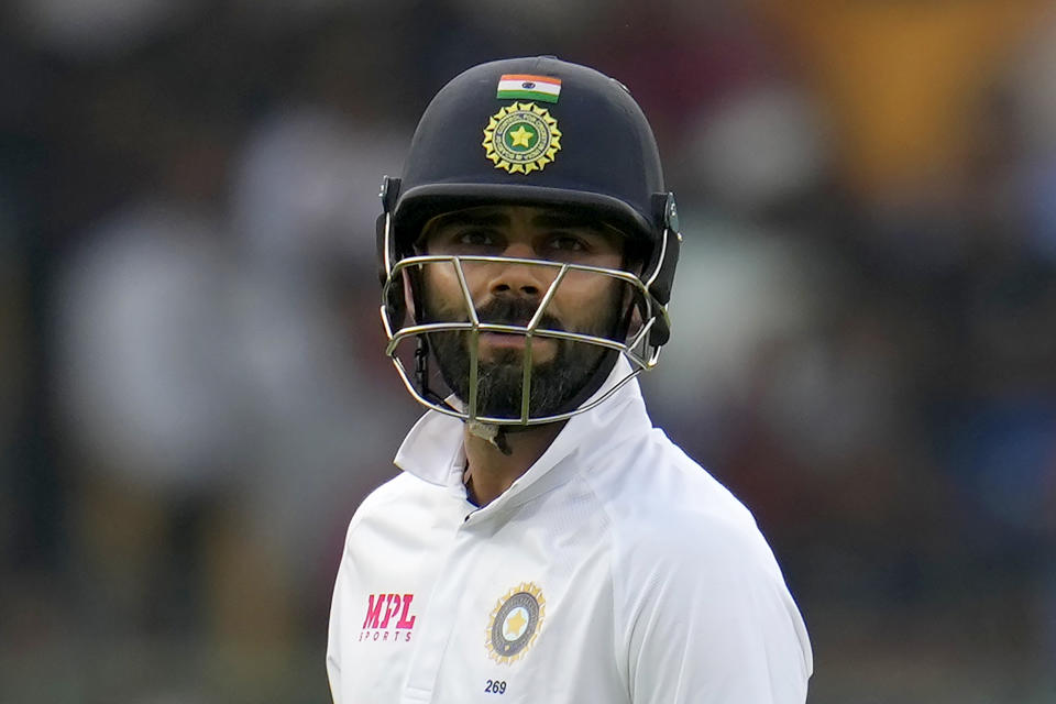 India's Virat Kohli watches the replay of his dismissal as he leaves the field after losing his wicket during the second day of the second cricket test match between India and Sri Lanka in Bengaluru, India, Sunday, March 13, 2022. (AP Photo/Aijaz Rahi)