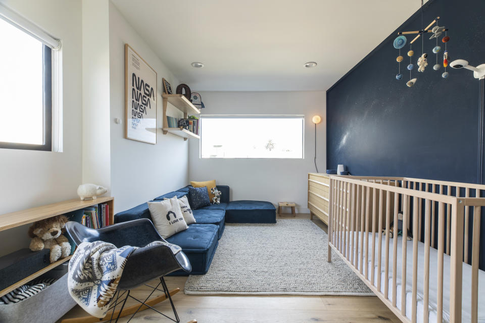 This image provided by Fernish shows an outer space inspired child's bedroom. Rachel Magana, senior visual designer at the sustainable furniture-rental company Fernish, says she picked up some cosmological decorating ideas from a colleague's recent nursery project. "Base your color palette around deep blue tones, then splash in bits of color like yellow, white or red,"(Dustin Walker Photography/Fernish via AP)