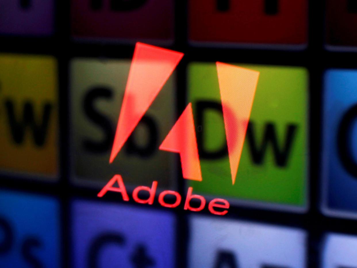 An Adobe logo and Adobe products are seen reflected on a monitor display and an iPad screen, in this picture illustration July 8, 2013: REUTERS/Dado Ruvic