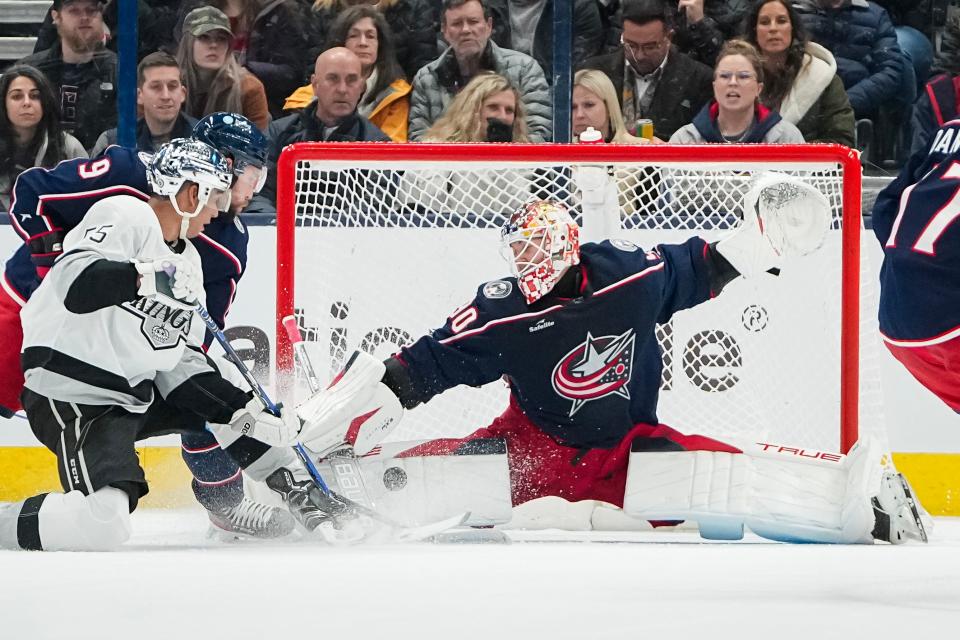 Dec 5, 2023; Columbus, Ohio, USA; Columbus Blue Jackets goaltender Elvis Merzlikins (90) saves a shot from Los Angeles Kings center Quinton Byfield (55) with defensive help from Columbus Blue Jackets defenseman Ivan Provorov (9) during the first period of the NHL game at Nationwide Arena.