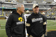 FILE - In this Oct. 19, 2019, file photo, Iowa head coach Kirk Ferentz talks with Purdue head coach Jeff Brohm, right, before an NCAA college football game in Iowa City, Iowa. Purdue offensive coordinator Brian Brohm went through his usual practice routine this week. He met with his older brother, Jeff, about game planning and the initial play-calling script as he prepared for Saturday's long-awaited season opener against Iowa. Less than a week after the Boilermakers fourth-year head coach tested positive for COVID-19 and was forced into isolation for 10 days, it's the other Brohm taking charge this weekend.(AP Photo/Charlie Neibergall, FIle)