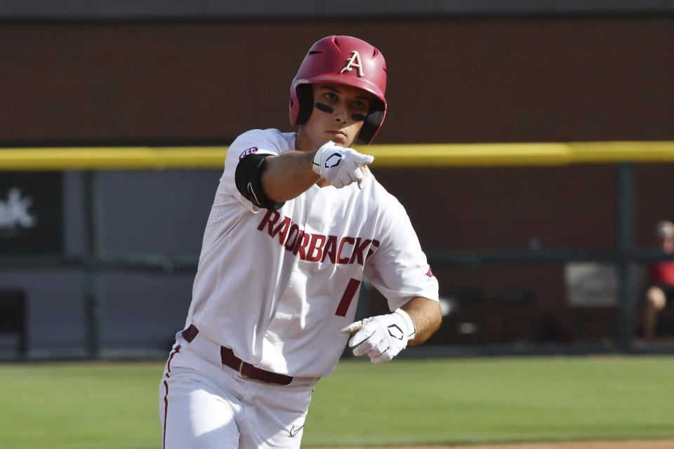 Arkansas batter Robert Moore (1) celebrates as he rounds the basses after hitting a home run against North Carolina State in the second inning of an NCAA college baseball super regional game Friday, June 11, 2021, in Fayetteville, Ark. (AP Photo/Michael Woods)