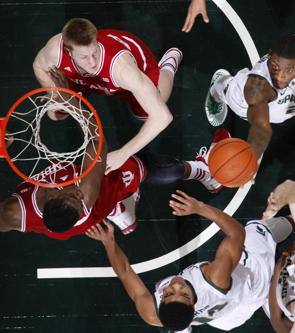 Michigan State's Branden Dawson, top right, grabs a rebound against Indiana's Jeff Howard, top left, and Noah Vonleh, bottom left, and Michigan State Gary Harris, bottom right, during the second half of an NCAA college basketball game, Tuesday, Jan. 21, 2014, in East Lansing, Mich. Michigan State won 71-66. (AP Photo/Al Goldis)