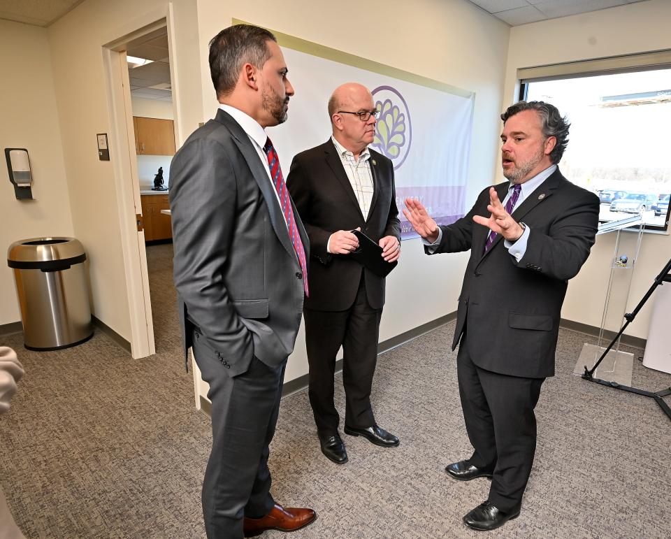 Stephen J. Kerrigan, president and CEO of Kennedy Community Health Center, right, speaks U.S. Rep. James P. McGovern, center, and Worcester City Manager Eric D. Batista after touring the center on Lincoln Street.