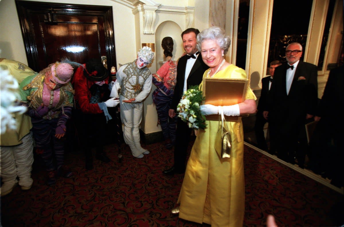 The Queen is greeted by the Cirque du Soleil’s Alegria at the Royal Variety Performance at the Victoria Palace Theatre in London (PA) (PA Archive)