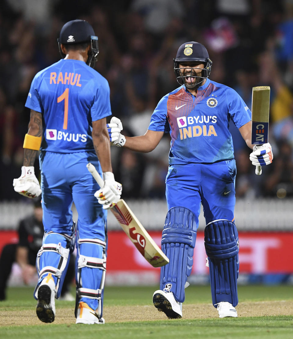 India's Rohit Sharma celebrates with KL Rahul, left, after hitting the winning runs in the super over to win the Twenty/20 cricket international between India and New Zealand in Hamilton, New Zealand, Wednesday, Jan. 29, 2020. (Andrew Cornaga/Photosport via AP)