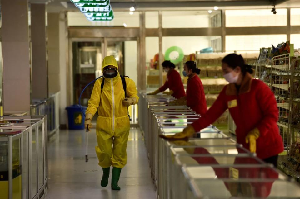 <div class="inline-image__caption"><p>Employees spray disinfectant and wipe surfaces as part of preventative measures against COVID at the Pyongyang Children’s Department Store in Pyongyang on March 18.</p></div> <div class="inline-image__credit">Kim Won Jin/AFP via Getty</div>