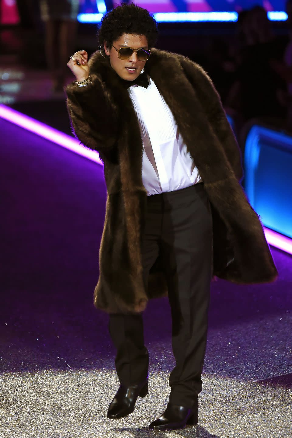 <p>Here is Bruno, casually wearing a tuxedo shirt under an long-hem fur. Very extra. Also, note the sunglasses inside - the continuation of an ongoing theme.</p>