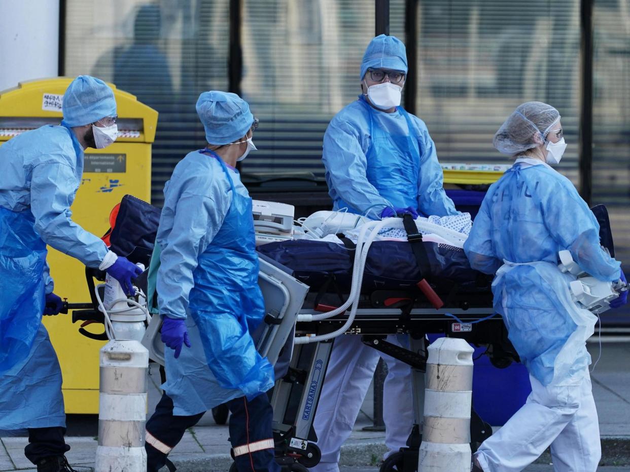 Medical staff move a patient from a train from Strasbourg to an ambulance: EPA