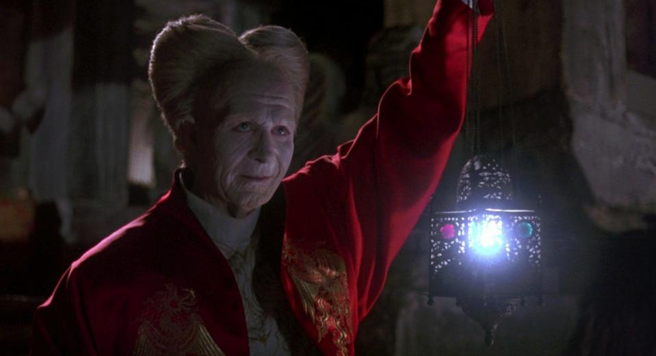 Gary Oldman as Dracula holding a light