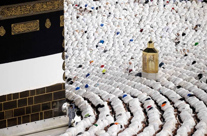 Muslim pilgrims pray in front of the al-Ka'bah as the annual Hajj pilgrimage season begins.  -/Saudi Press Agency/dpa