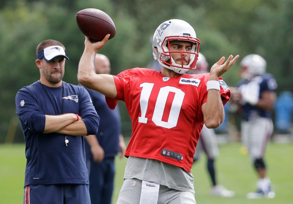 New England Patriots' Jimmy Garoppolo (10) winds up for a pass as offensive coordinator Josh McDaniels, left, looks on during an NFL football practice, Wednesday, Sept. 7, 2016, in Foxborough, Mass. (AP Photo/Steven Senne)