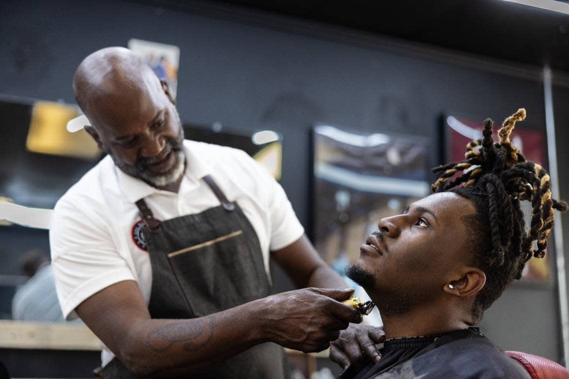 Brian Mack, left, cuts his son’s hair, B.J., at House of Hoops Barbershop in Charlotte, N.C., on Monday, July 1, 2024.