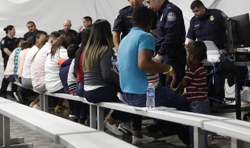 Migrants who are applying for asylum in the United States go through a processing area at a new tent courtroom at the Migration Protection Protocols Immigration Hearing Facility, in Laredo, Texas. More immigration judges are overseeing hearings remotely in secretive tent courts the U.S. government has built along the southern border. (Photo: Eric Gay/AP)