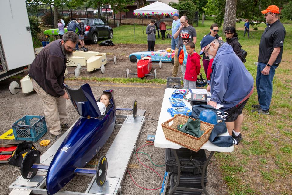 Seth Cardon and his son Adrian, 12, from Camano Island, Washington, get their master car weighed before the Best in the West Classic All-American Rally at Bush's Pasture Park.