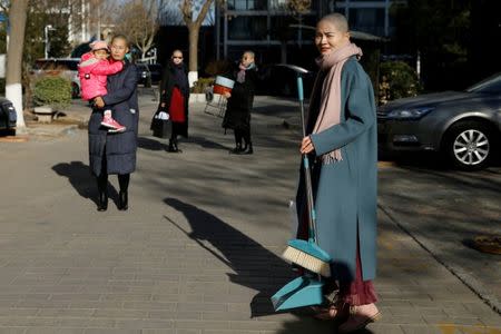 Li Wenzu, Wang Qiaoling, Liu Ermin and Yuan Shanshan, wives of prominent Chinese rights lawyers, look on after shaving their heads in protest over the government's treatment of their husbands in Beijing, China, December 17, 2018. REUTERS/Thomas Peter