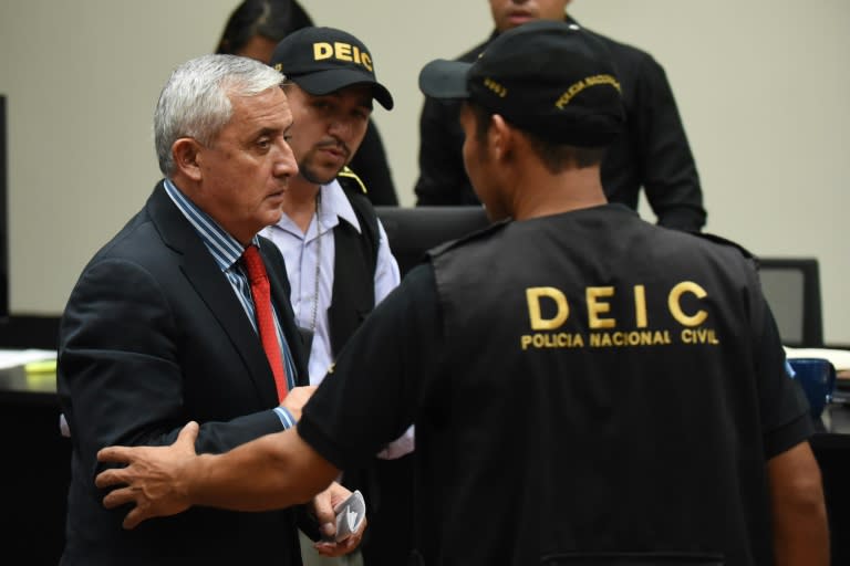 Guatemala's former president Otto Perez (L) is taken into custody at the end of a hearing at the Supreme Court in Guatemala City on September 3, 2015