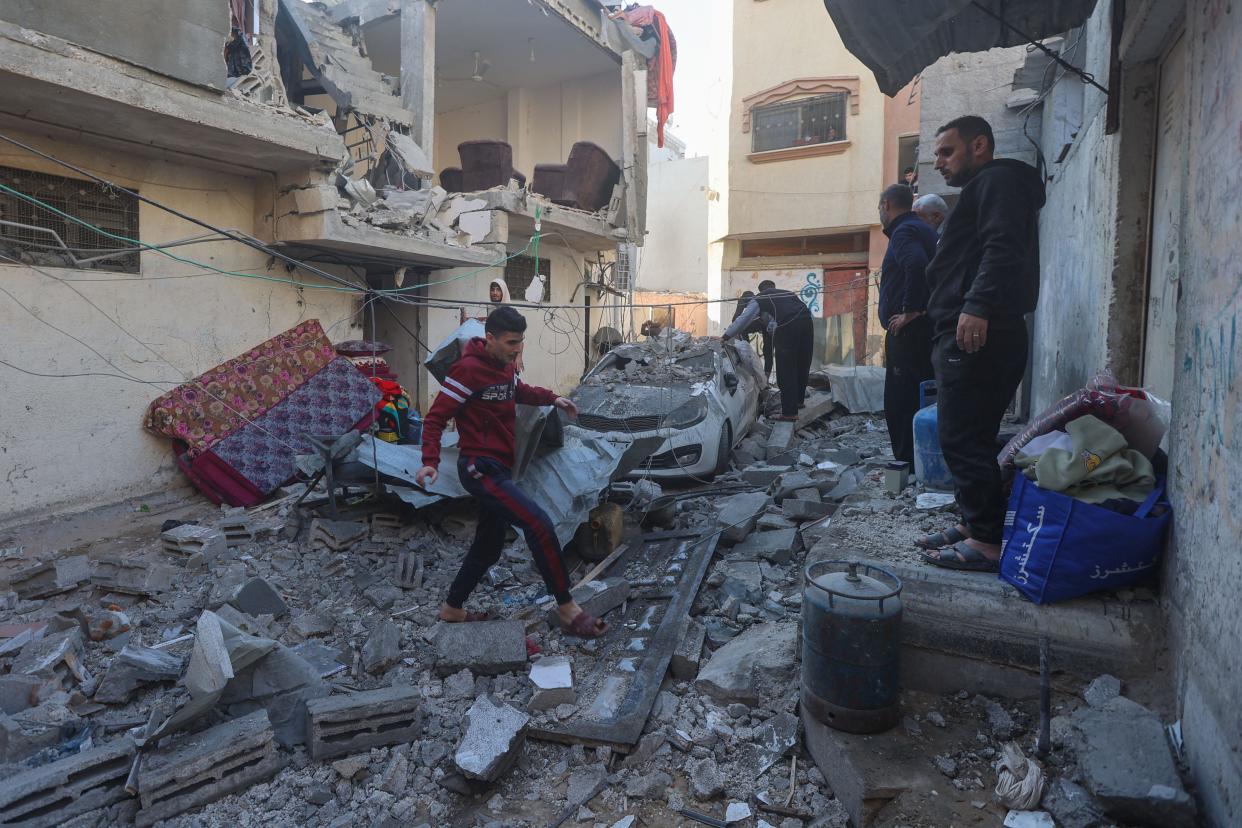 Palestinians inspect the rubble following Israeli bombardment on Khan Yunis in the southern Gaza Strip on Dec. 8, 2023, amid continuing battles between Israel and the Palestinian militant group Hamas.