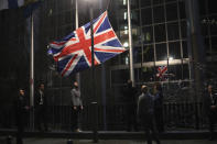 FILE - In this Friday, Jan. 31, 2020 file photo, the Union flag is lowered and removed from outside of the European Parliament in Brussels. It’s more than four years since Britain voted to leave the European Union, and almost a year since Prime Minister Boris Johnson won an election by vowing to “get Brexit done.” Spoiler alert: It is not done. As negotiators from the two sides hunker down for their final weeks of talks on an elusive trade agreement, Britain and the EU still don’t know whether they will begin 2021 with an organized partnership or a messy rivalry.(AP Photo/Francisco Seco, File)