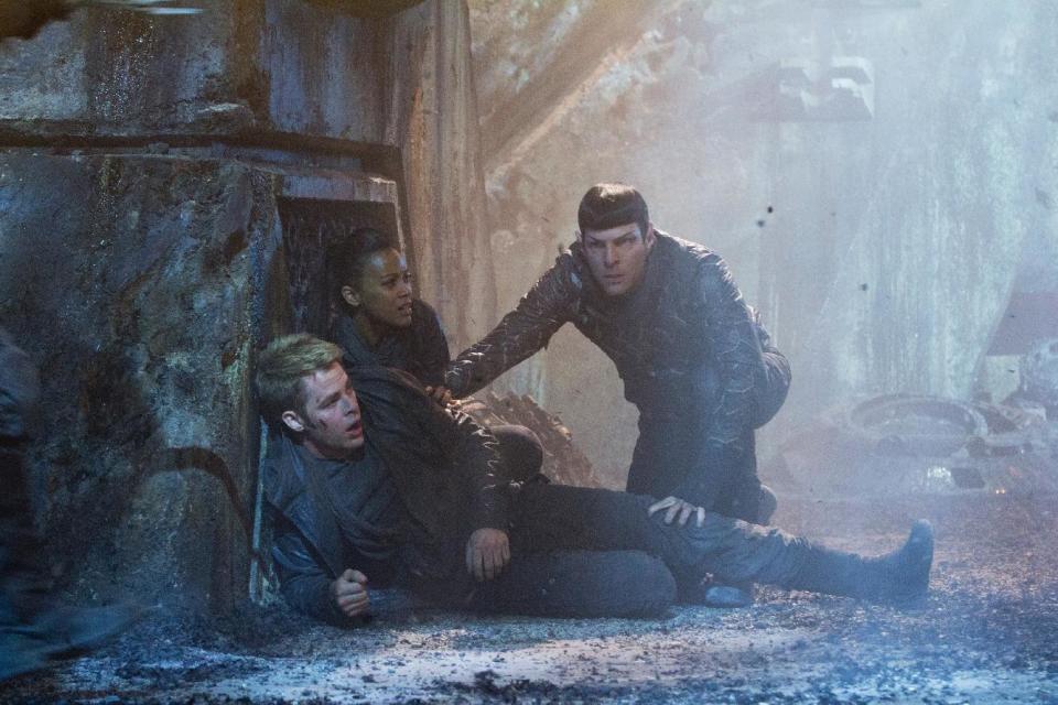 This undated publicity film image released by Paramount Pictures shows Chris Pine as Kirk, Zoe Saldana as Uhura and Zachary Quinto as Spock in a scene from the movie, "Star Trek Into Darkness," from Paramount Pictures and Skydance Productions. (AP Photo/Paramount Pictures, Zade Rosenthal)