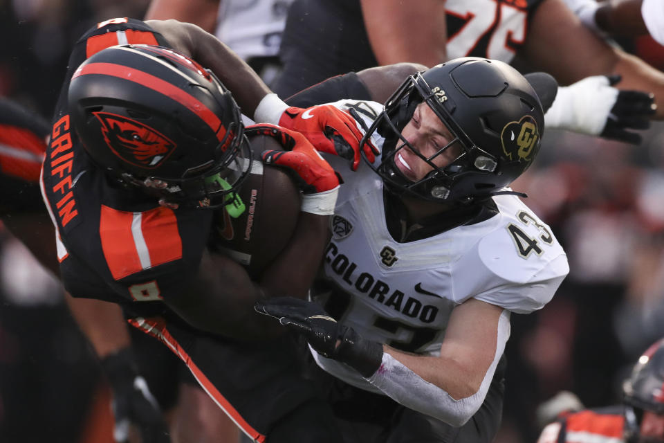 Oregon State running back Jam Griffin, left, is brought down by Colorado safety Trevor Woods (43) during the first half of an NCAA college football game on Saturday, Oct. 22, 2022, in Corvallis, Ore. (AP Photo/Amanda Loman)