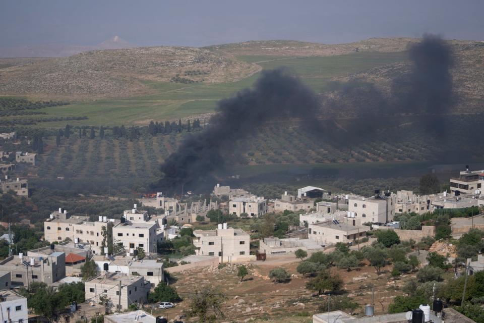 Israeli settlers set fire to Palestinian villages in the West Bank on Saturday (AP)