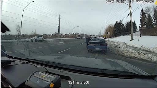 A York Regional Police officer talks to a driver in a still image taken from a video posted to social media on Friday. (York Regional Police/X - image credit)