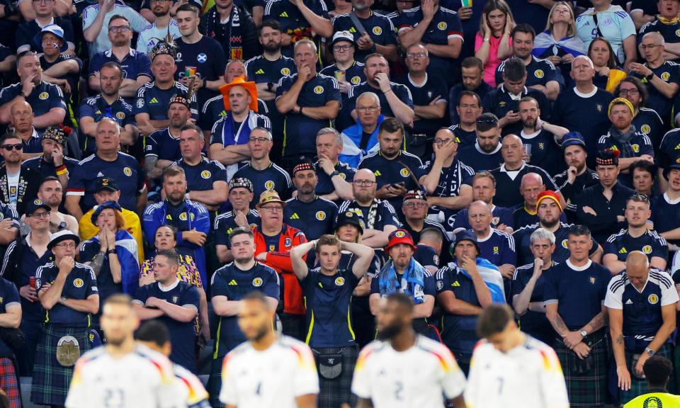 <span>Scotland fans look dejected after Florian Wirtz scored the opening goal of Euro 2024.</span><span>Photograph: Tom Jenkins/The Guardian</span>