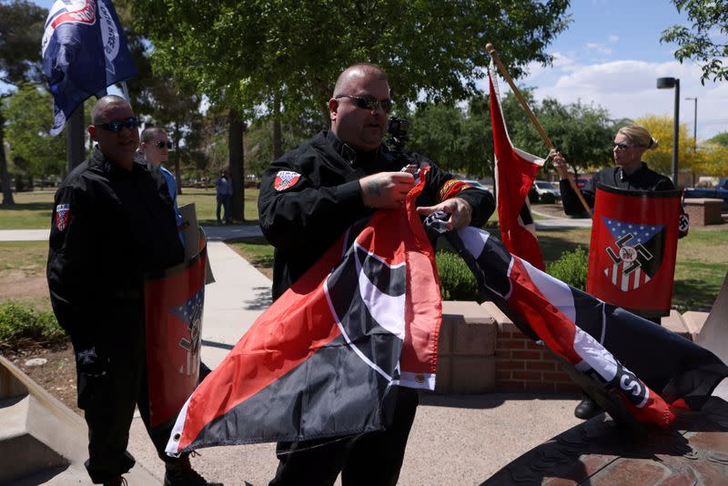 FILE PHOTO: Burt Colucci of the white nationalist group National Socialist Movement destroys a flag of the anti-facist movement