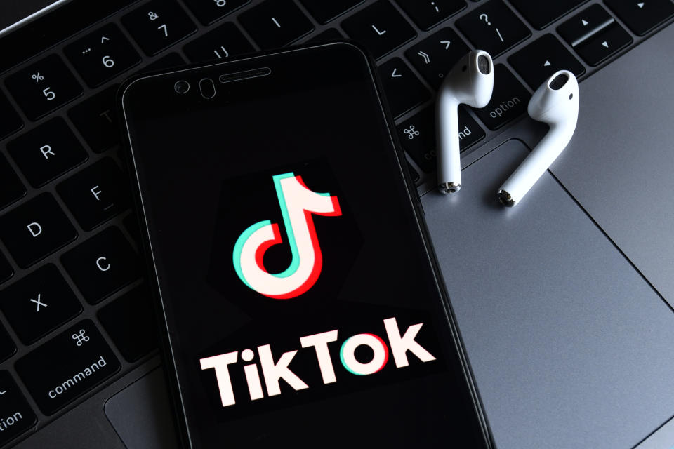HAIKOU, HAINAN, CHINA - 2020/08/23: In this photo illustration, a TikTok logo seen displayed on a smartphone with a computer in the background. ByteDance, parent company of popular video-sharing app TikTok on Sunday confirmed it would be filing a lawsuit on Monday local time against the Trump administration over the executive order signed by President Donald Trump banning its service in the United States. (Photo Illustration by Sheldon Cooper/SOPA Images/LightRocket via Getty Images)