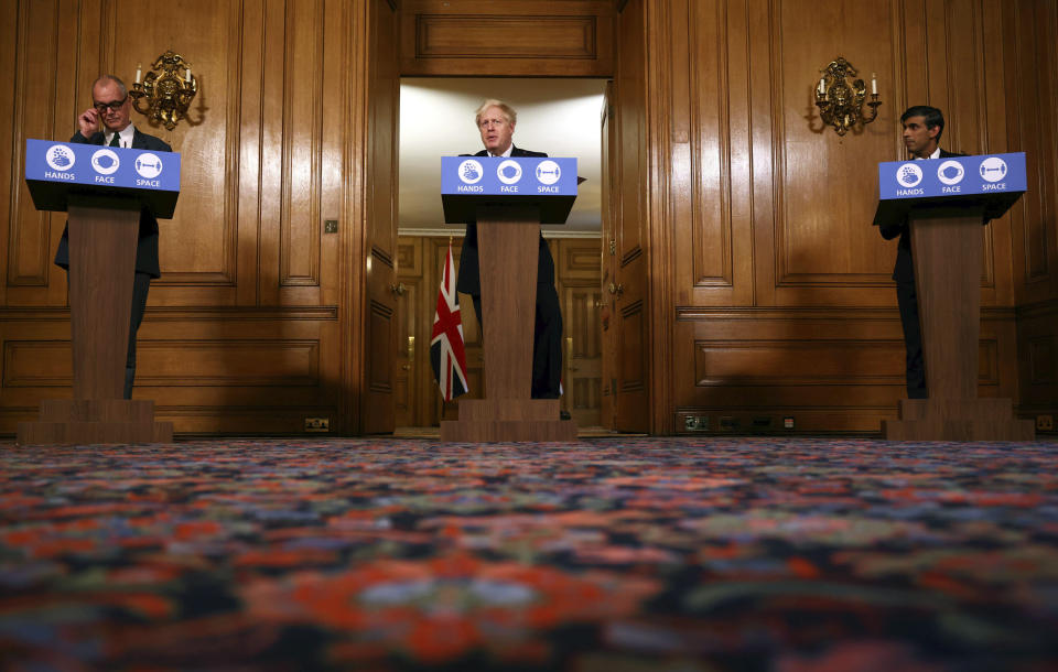 From left, Britain's Chief scientific adviser Sir Patrick Vallance, Prime Minister Boris Johnson and Chancellor of the Exchequer Rishi Sunak take part in a coronavirus briefing, in Downing Street, London, Thursday, Oct. 22, 2020. (Henry Nicholls/Pool Photo via AP)