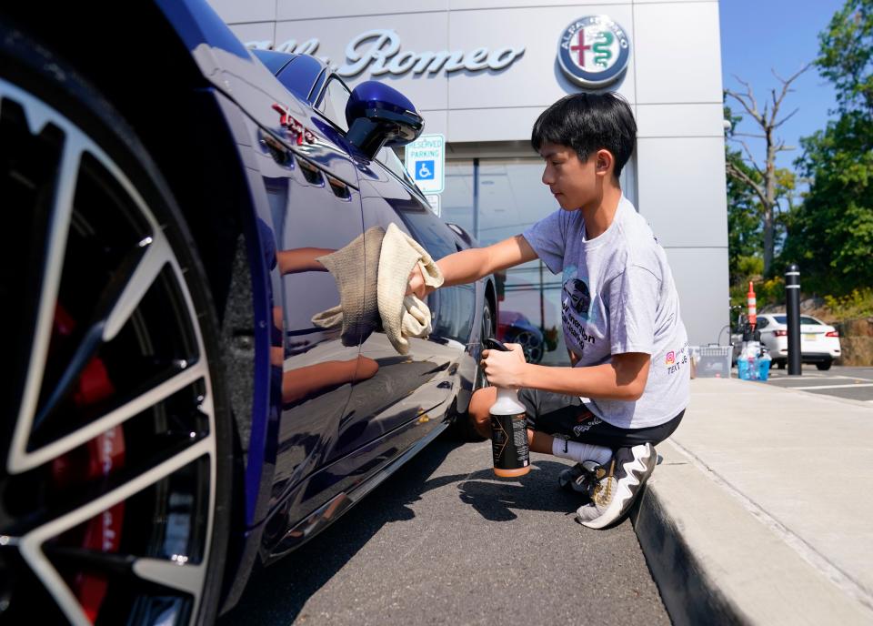 Tyler Poon details a car at Maserati of Englewood Cliffs on Wednesday, Aug. 9, 2023. The 13-year-old Edgewater resident owns New Generation Car Cleaning, which offers luxury car detailing services in North Jersey.