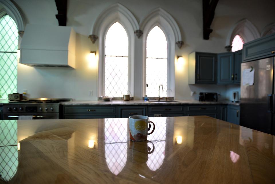 A mug in the kitchen of the converted church reminds the family to keeping breathing amid renovation chaos.