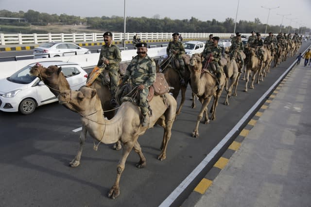 Border Security Force soldiers on the route that  Donald Trump will take in Ahmedaba