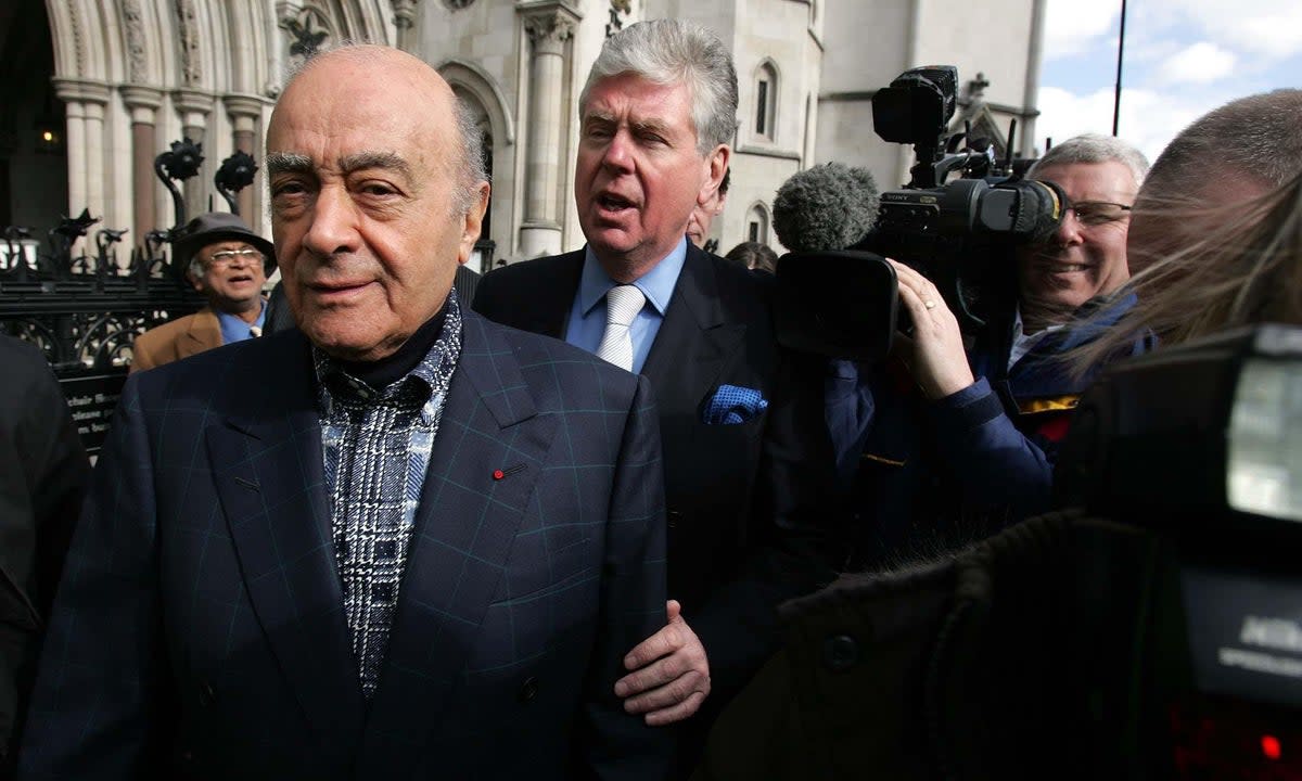 Mohamed Al Fayed, who has died aged 94, and his director of public affairs, Michael Cole (PA)