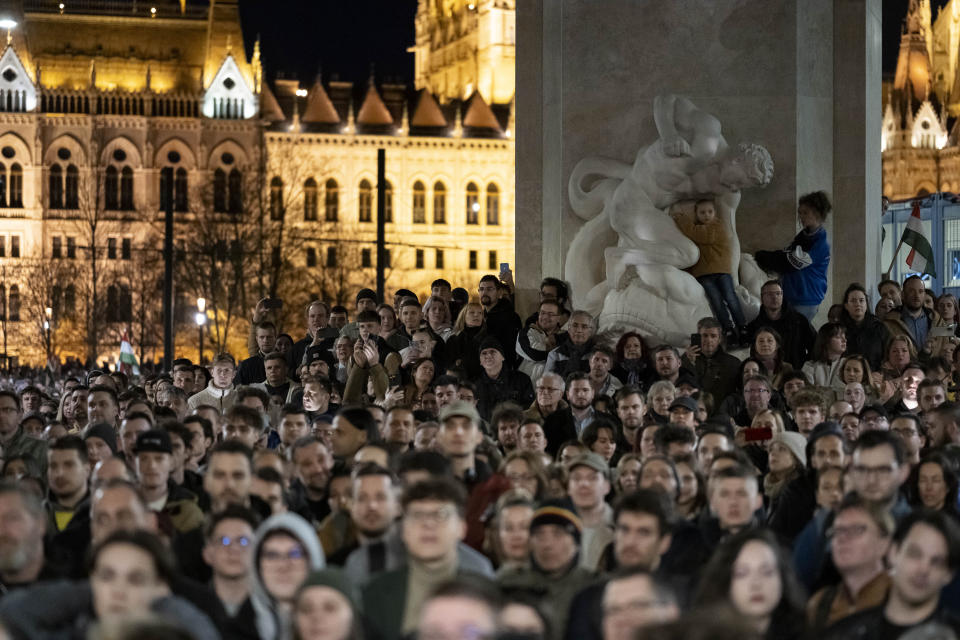 People listen to the speech of former Hungarian government insider Peter Magyar next to Kossuth Square on Tuesdy, in Budapest, Hungary, March 26, 2024. Magyar on Tuesday released a recording that he claims proves senior officials in the government of Prime Minister Viktor Orban manipulated court documents to cover up their involvement in a corruption case. (AP Photo/Denes Erdos)