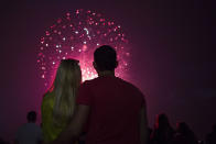 <p>A couple enjoys the fireworks at the Washington Monument in Washington D.C. on July 4, 2017. (Calla Kessler/The Washington Post via Getty Images) </p>