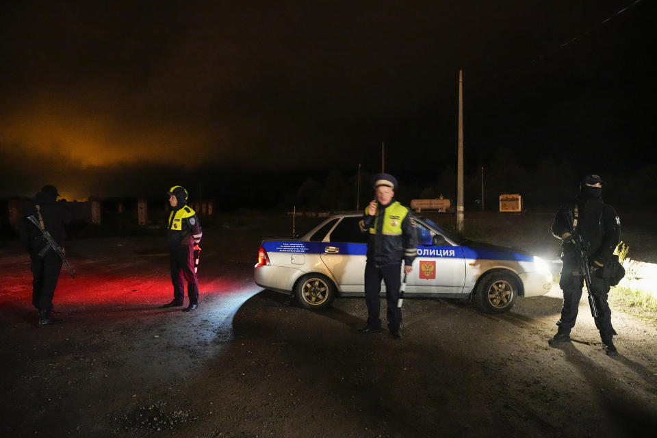 Russian servicemen block a road near a private jet crash, near the village of Kuzhenkino, Tver region, Russia, early Thursday, Aug. 24, 2023. Officials say a private jet has crashed over Russia, killing all 10 people on board. Mercenary chief Yevgeny Prigozhin was on the passenger list, and Russia’s civil aviation agency says he was on board. (AP Photo/Alexander Zemlianichenko)