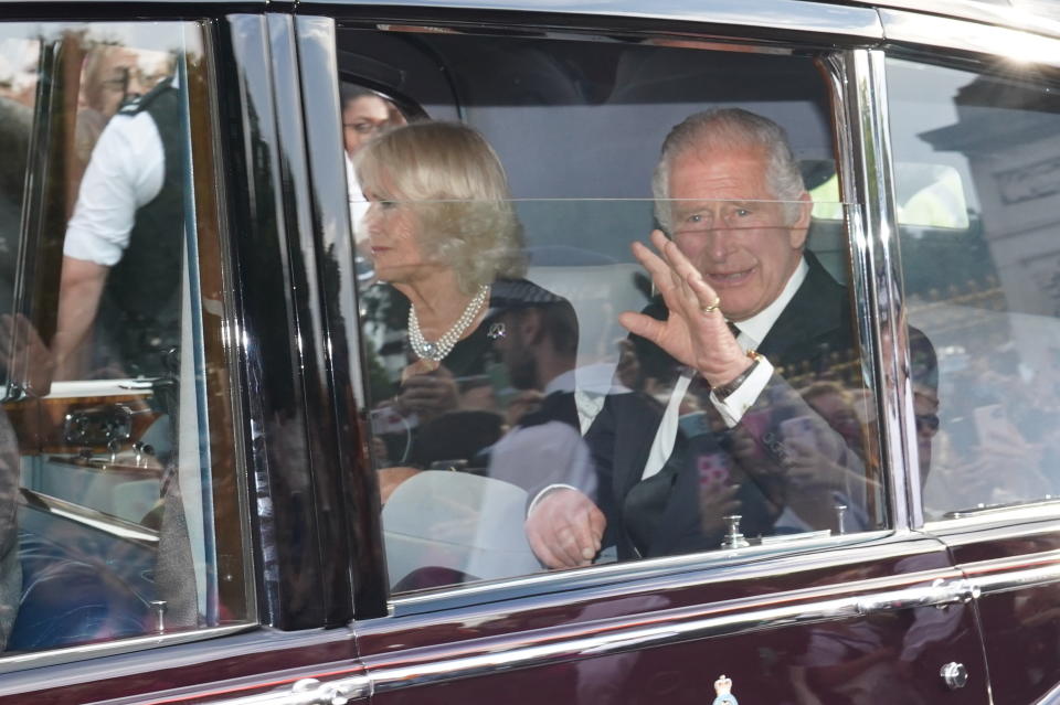 A car carrying Britain's King Charles III and Camilla, the Queen Consort, leaves Buckingham Palace following the death of Queen Elizabeth II on Thursday in London, Friday, Sept. 9, 2022. Queen Elizabeth II, Britain's longest-reigning monarch and a rock of stability across much of a turbulent century, died Thursday Sept. 8, after 70 years on the throne. She was 96. (James Manning/PA via AP)