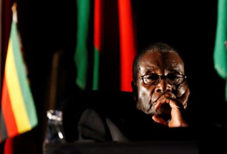 FILE PHOTO: Zimbabwean President Robert Mugabe watches a video presentation during the summit of the Southern African Development Community (SADC) in Johannesburg, South Africa August 17, 2008. REUTERS/Mike Hutchings/File Photo