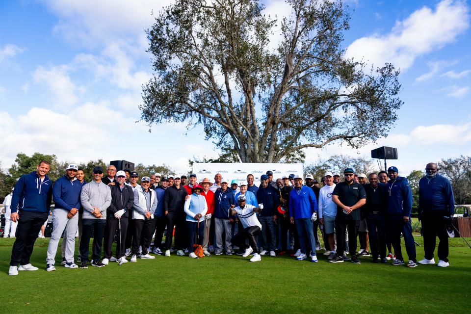 The entire field lines up for a photo shoot at the “Mr. October Celebrity Golf Classic” Monday in Palm City.