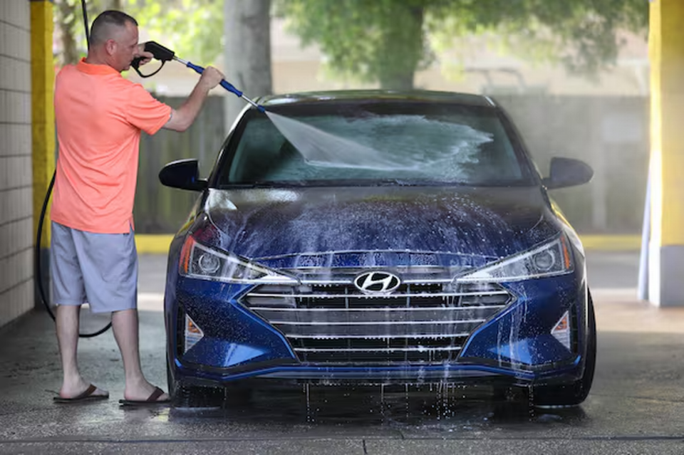 Bobby Dorries of Clearwater washes his car April 1 in Dunedin. Multiple studies have found that the pollen season is growing longer and more intense because of climate change.