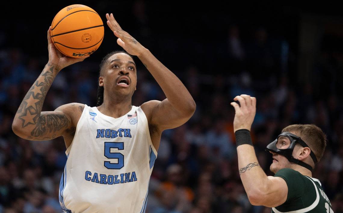 North Carolina’s Armando Bacot (5) works his way to the basket against Michigan State’s Carson Cooper (15) during the second half on Saturday, March 23, 2024, during the second round of the NCAA Tournament at Spectrum Center in Charlotte, N.C. Bacot scored 18 points in the Tar Heels’ victory.