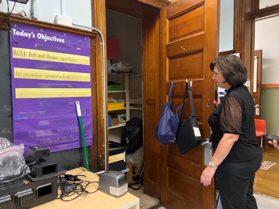 Sandra Auletta looks inside her third grade English classroom closet at School 3 in Paterson, where wastewater leaks from the floor above and a black stain spreads across the ceiling.