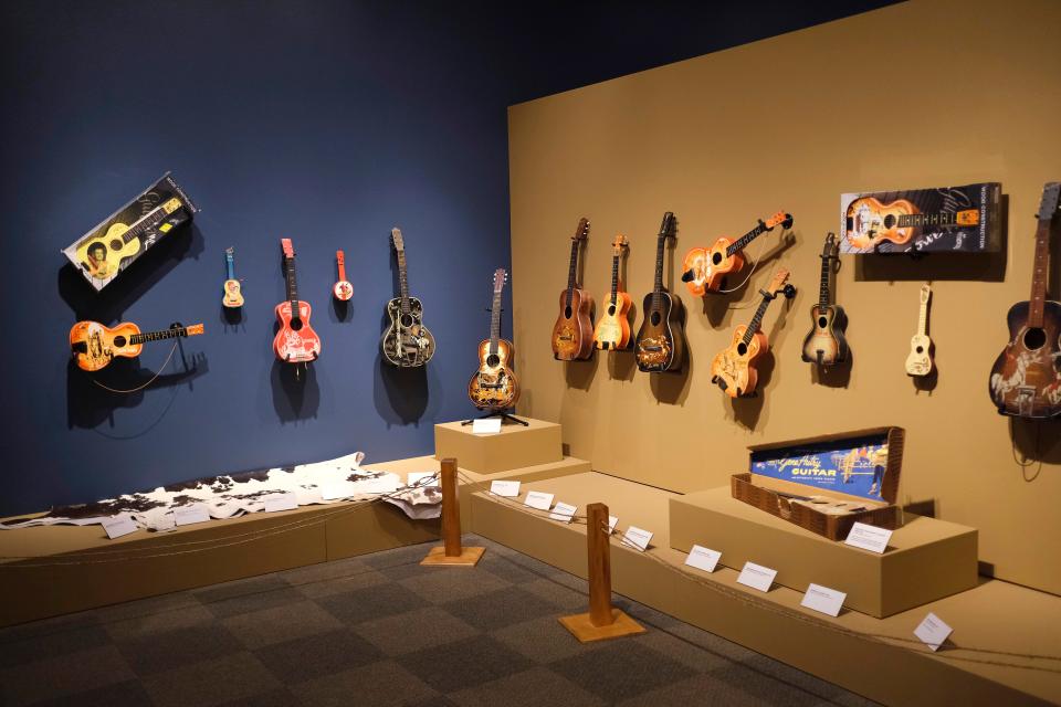 An array of toy guitars is on view in the National Cowboy & Western Heritage Museum exhibit "Playing Cowboy" Friday, March 24, 2023, in Oklahoma City. On view through May 7, "Playing Cowboy" showcases Western books, games and toys for children.